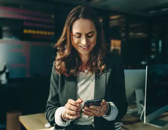 Long Haired Brunette Woman Smiling At Phone