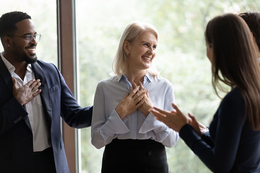 business woman smiling amongst colleagues