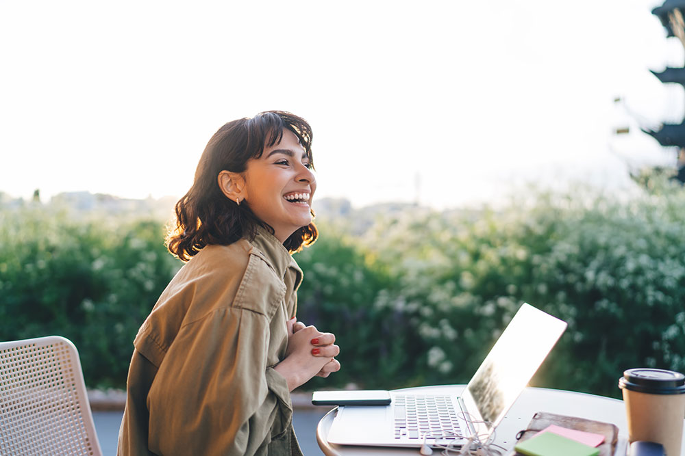 Woman Laughing At Laptop