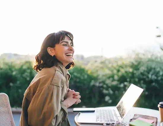 Woman Laughing At Laptop