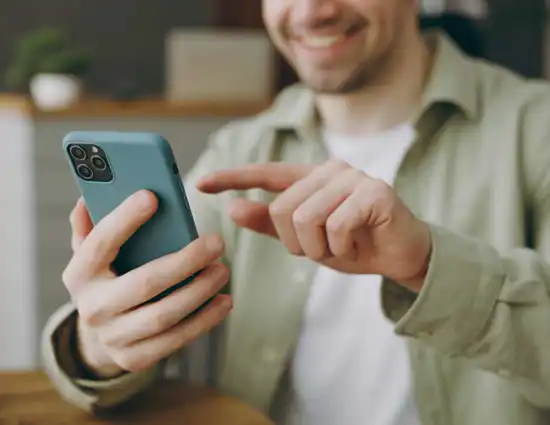 Man Lifting Finger To Use Blue Cell Phone