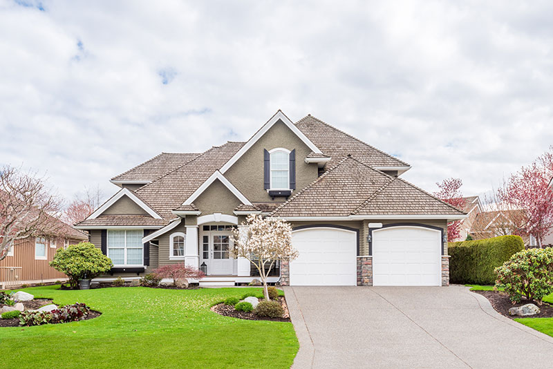 large brown house with double garage