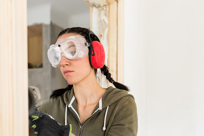Woman Polishing Door Frame During Renovation