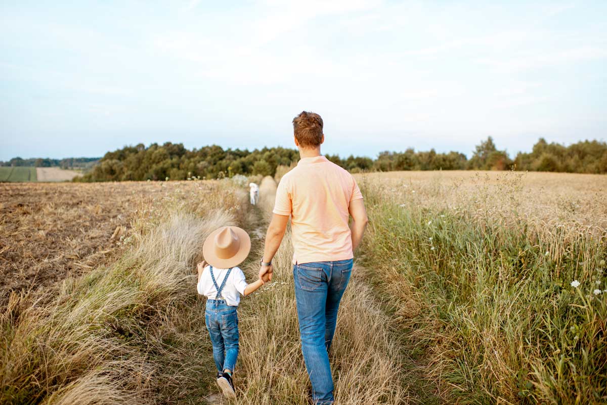 Father And Son Walking In The Field 