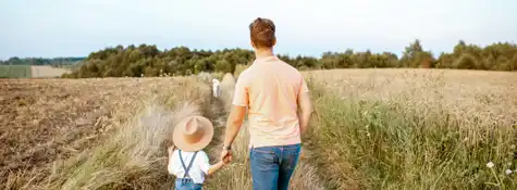 Father And Son Walking In The Field 