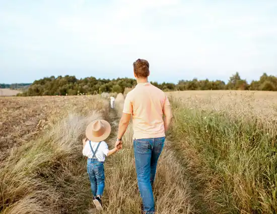 Father And Son Walking In The Field 