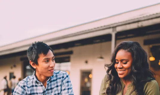 Women smiling and eating around a table