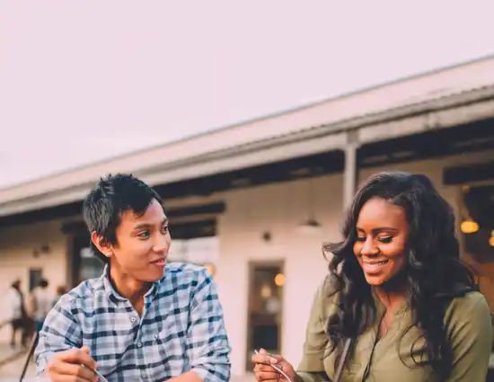 Women smiling and eating around a table