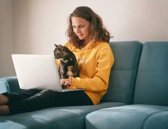 Young Brunette Holding Cat And Computer
