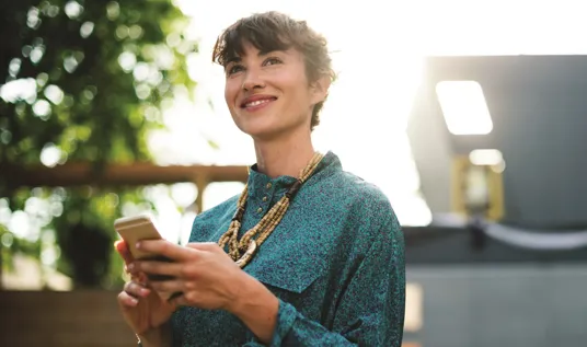 Woman smiling at phone