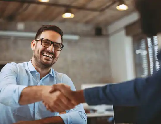Man In Blue Button Up Shaking Hands