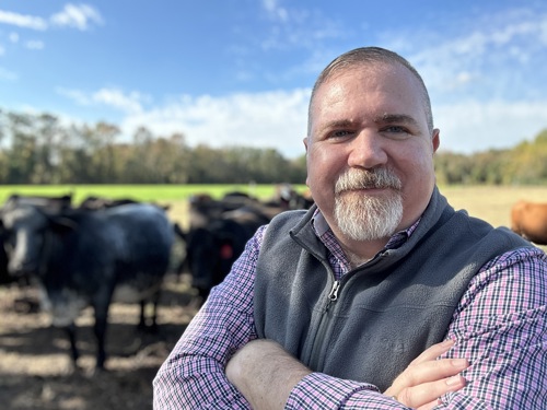 Nelson Powell on personal farm with cows