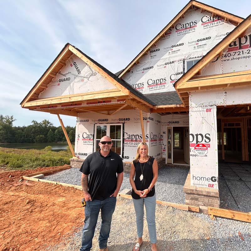 Couple In Front Of Construction House