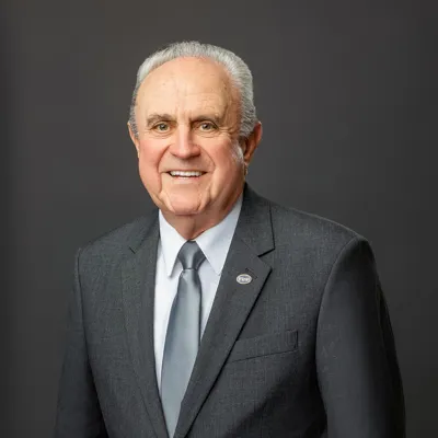 Ronald L. Barrett in a dark brown suit