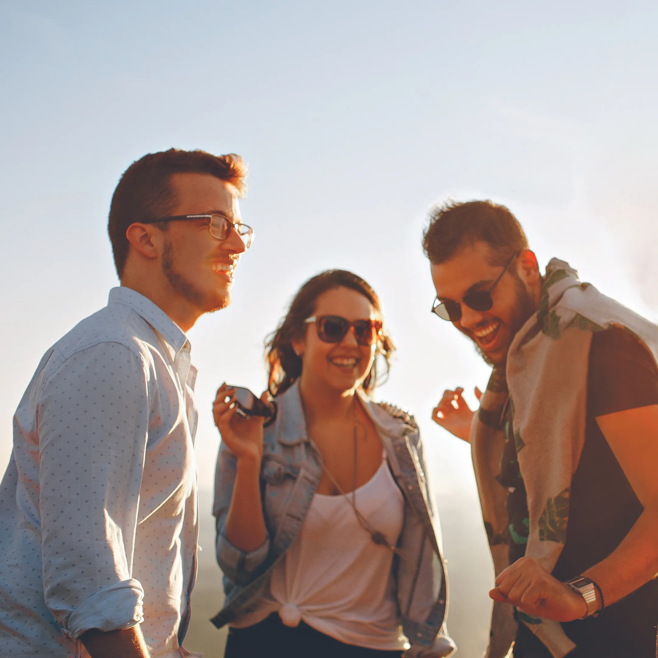 Three friends smiling and dancing