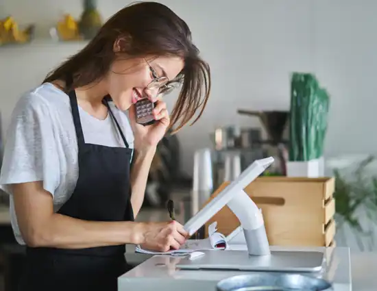 Woman Taking Order On Pos