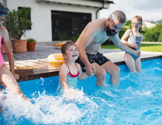 Father With Three Daughters Outdoors In The Backyard