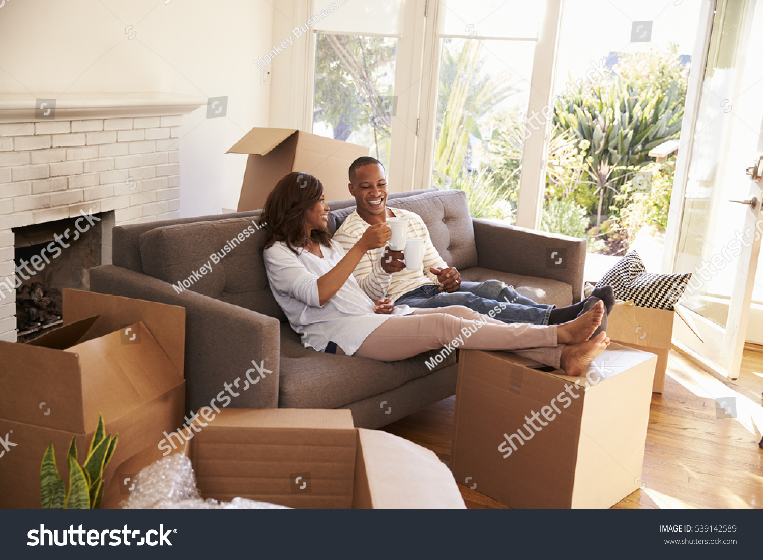 Stock Photo Couple On Sofa Taking A Break From Unpacking On Moving Day 539142589