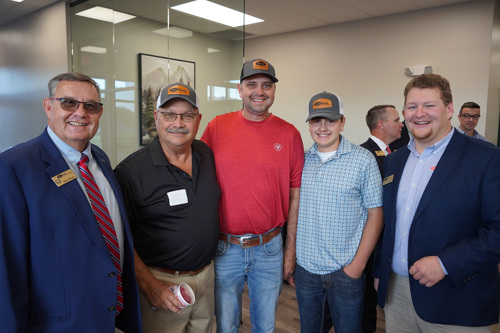 Mark Nelson and Justin Scarlett smiling with customers
