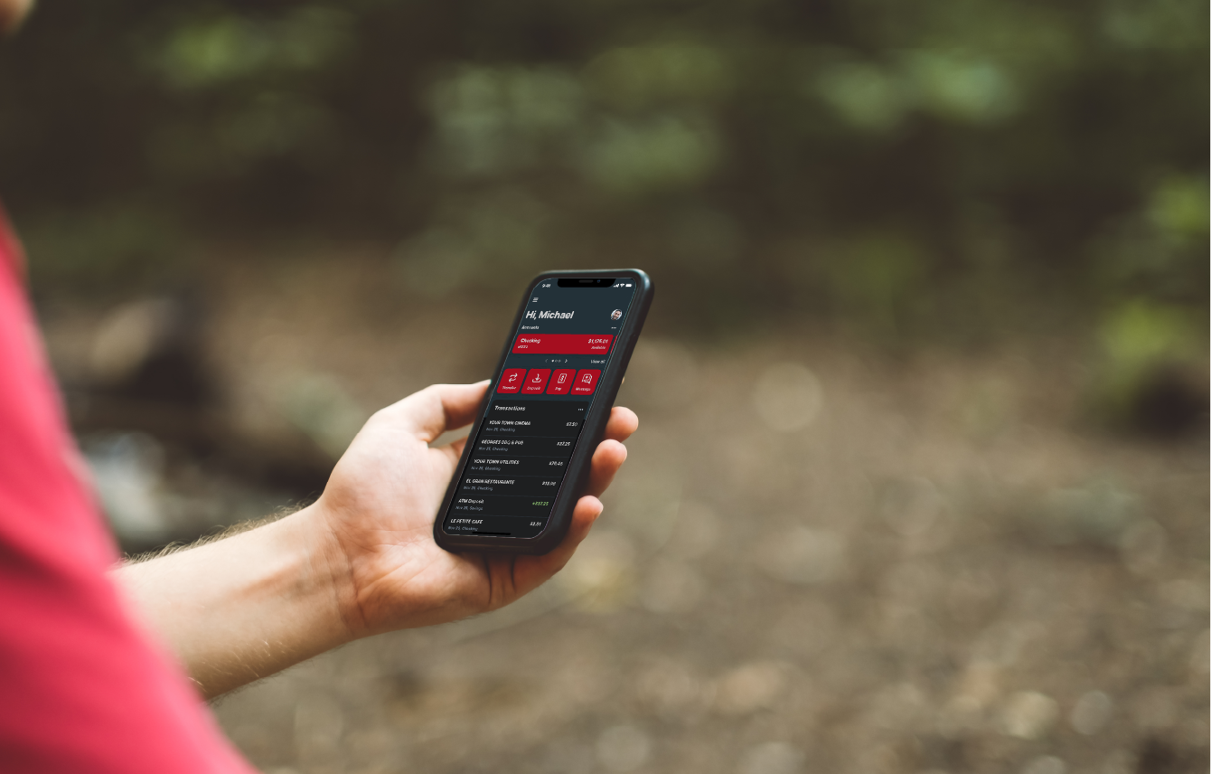 Man holding phone with digital banking app