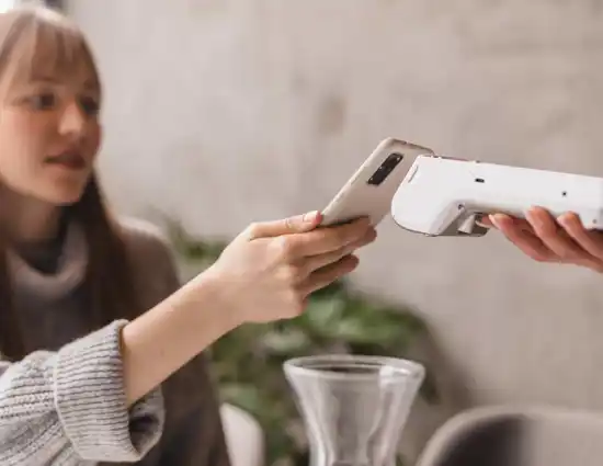 Woman Holding Phone To Google Card Reader
