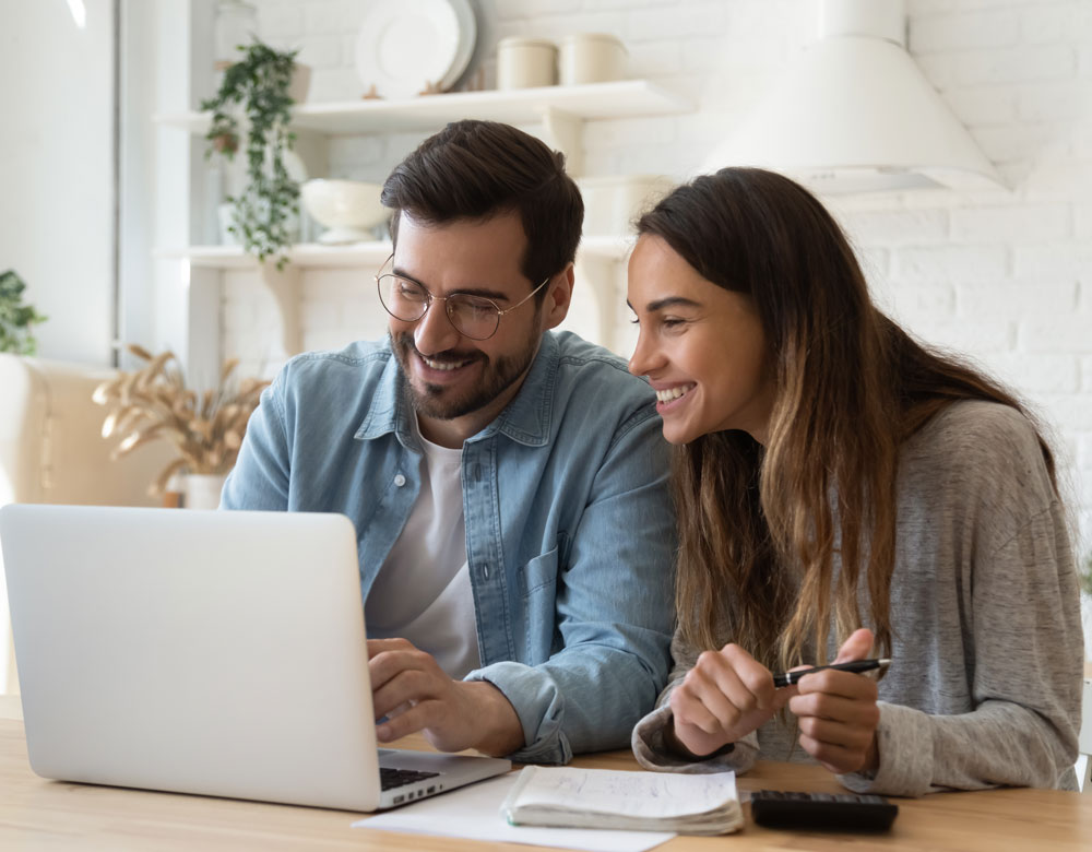 Couple Smiling At Laptop
