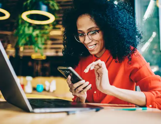 Women Smiling Looking At Phone