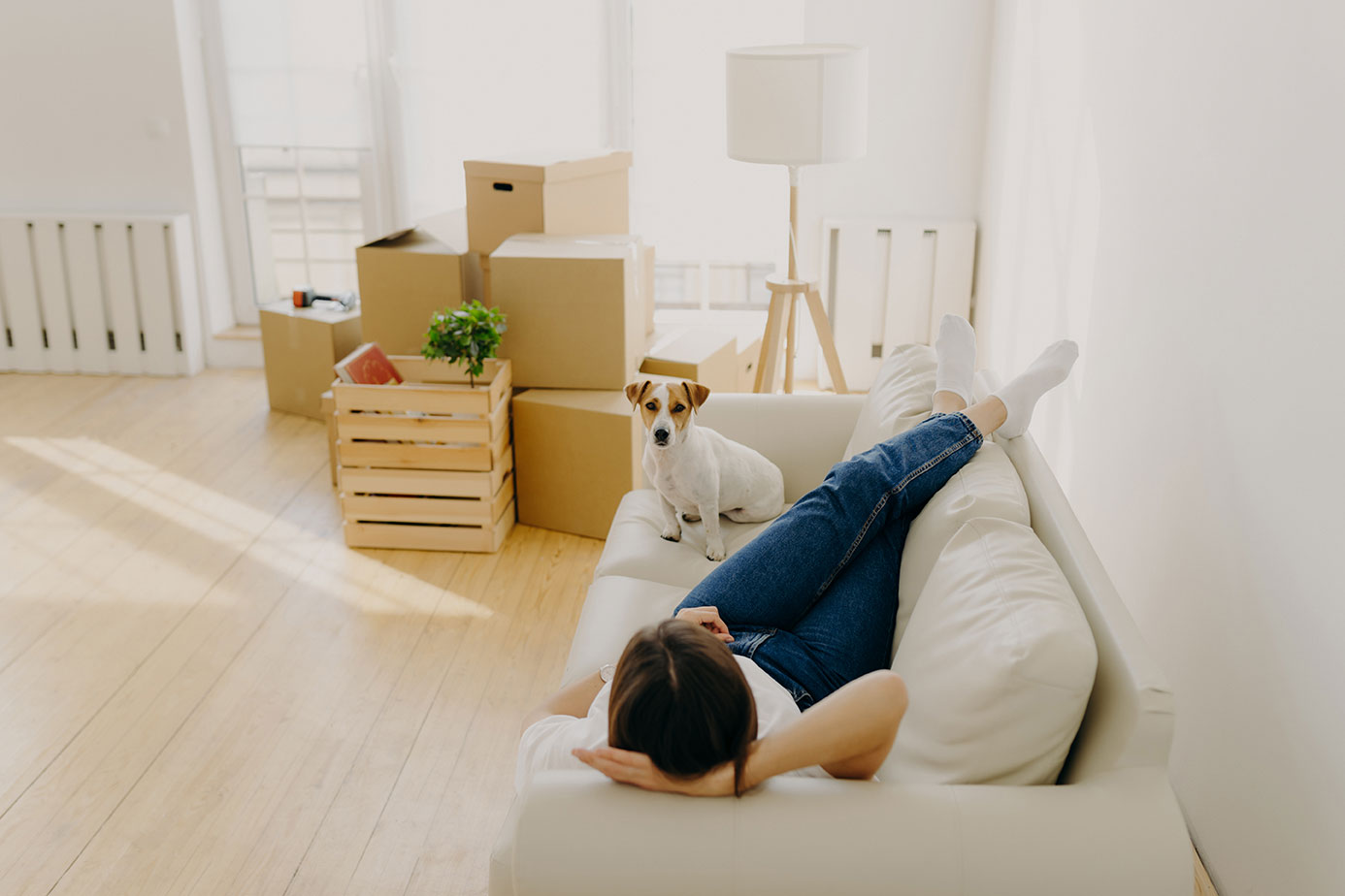 Woman Rests On Sofa With Favorite Pet