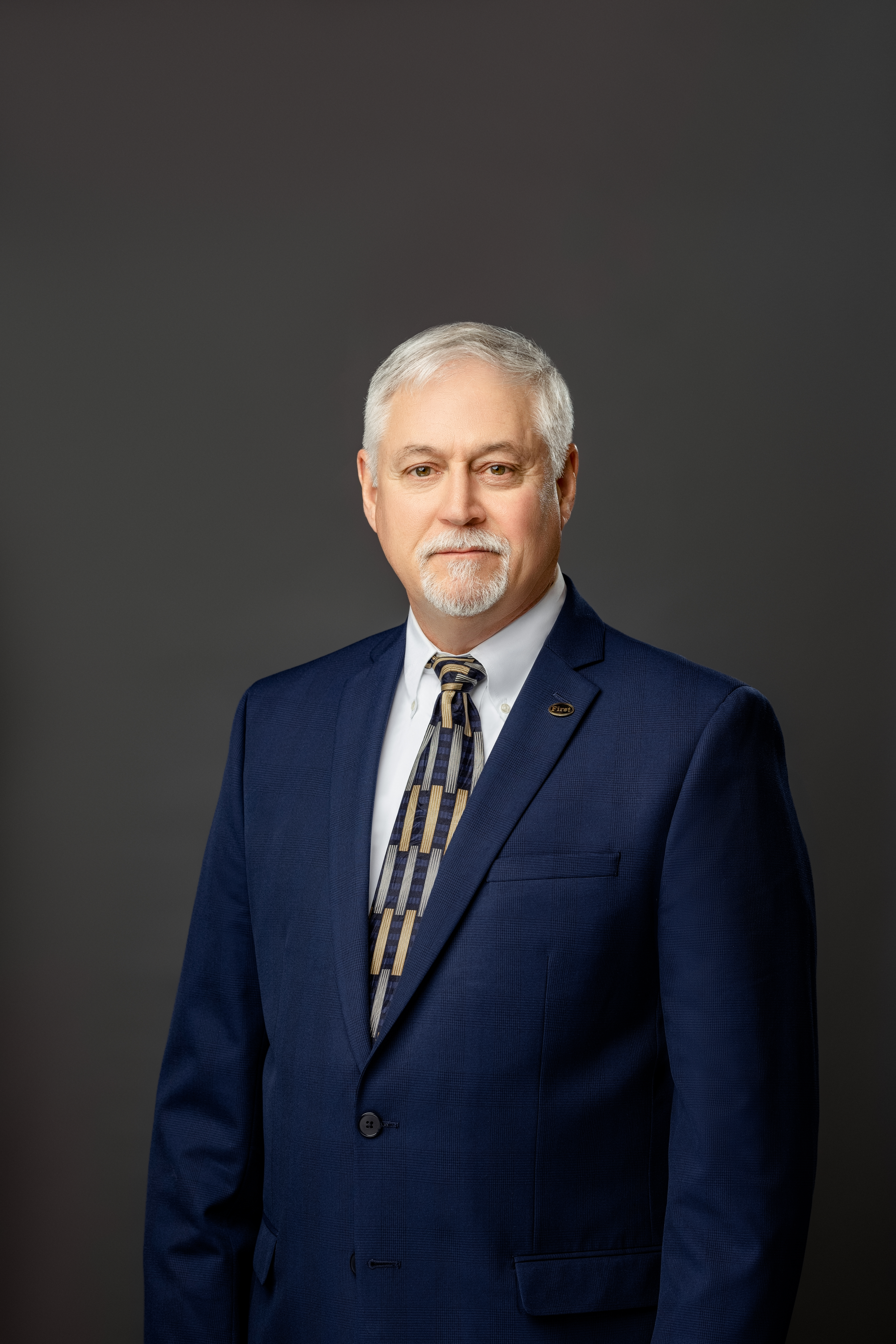 Nathan 'Trent' Yates in dark blue suit and patterned tie