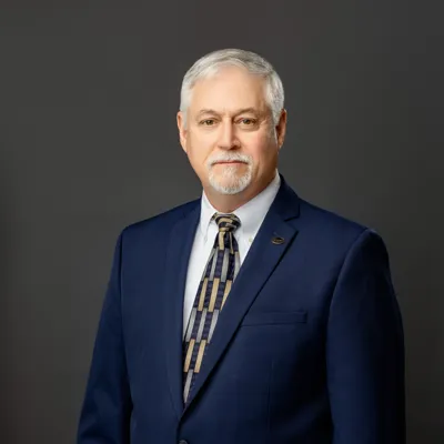 Nathan 'Trent' Yates in dark blue suit and patterned tie