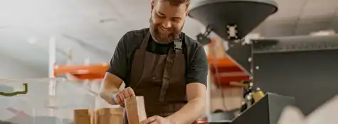 Business Owner Weighs Paper Bag With Coffee Beans 2023 11 27 04 49 39 Utc